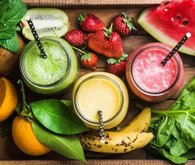 freshly blended fruit smoothies of various colors and tastes