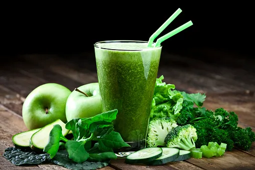 green vegetable juice on rustic wood table