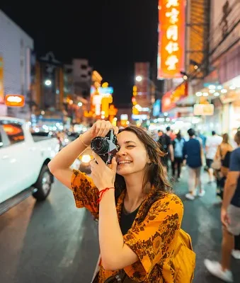 woman photographing with camera in chinatown bangkok