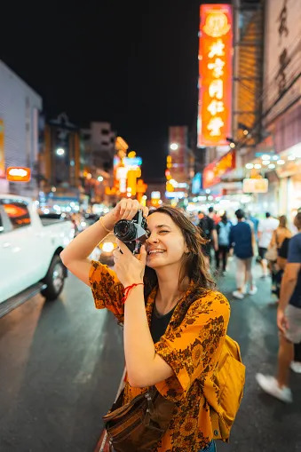 woman photographing with camera in chinatown bangkok